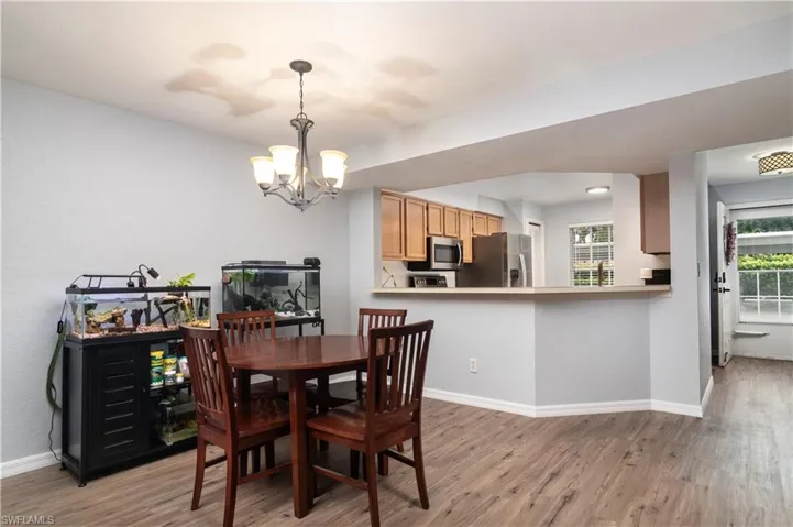 Dining space with light wood-style flooring and a chandelier