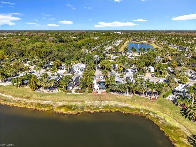Aerial overview of property's location with a large body of water and nearby suburban area