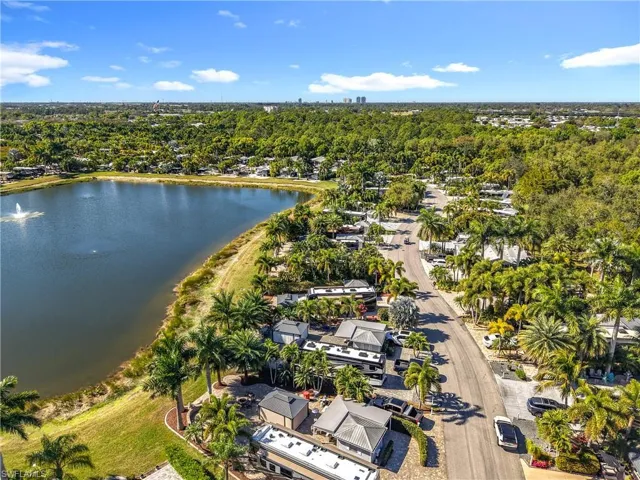 Aerial view of property's location with a nearby body of water and nearby suburban area