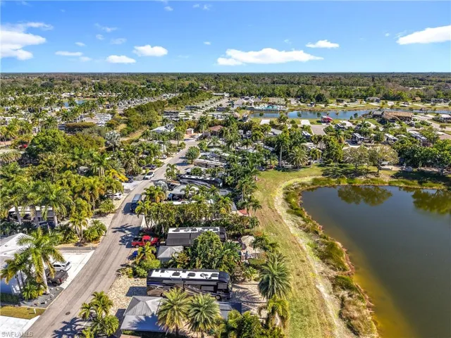Aerial overview of property's location featuring a nearby body of water and nearby suburban area
