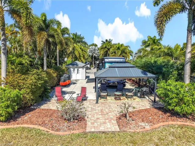 View of patio / terrace featuring a storage shed, a gazebo, and view of scattered trees