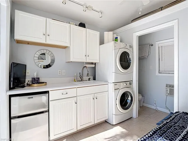 Washroom with stacked washing machine and dryer