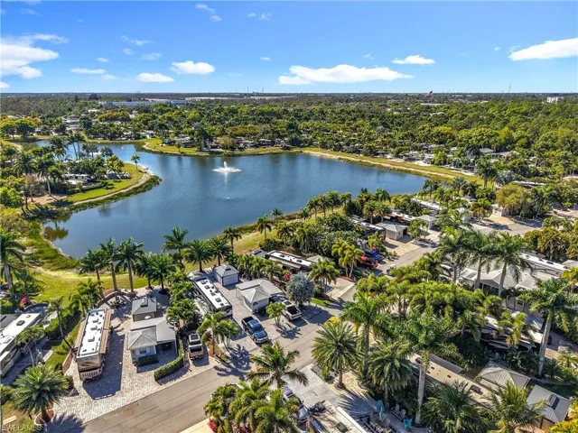View of property location featuring a nearby body of water and a tree filled landscape