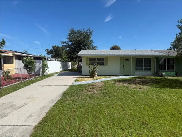 Single story home with driveway and roof with shingles