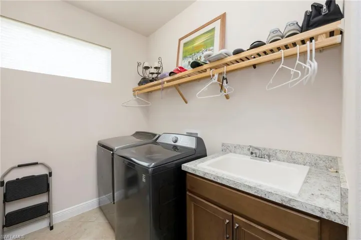 Laundry room with washer and clothes dryer and cabinet space