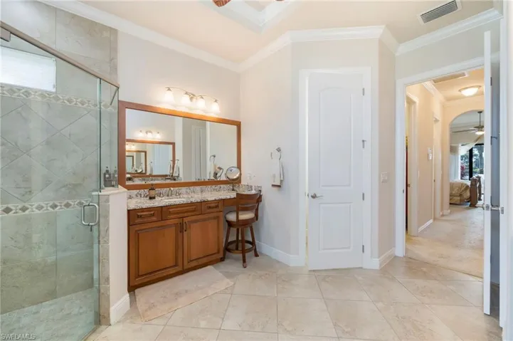 Full bath featuring healthy amount of natural light, a ceiling fan, ornamental molding, and vanity