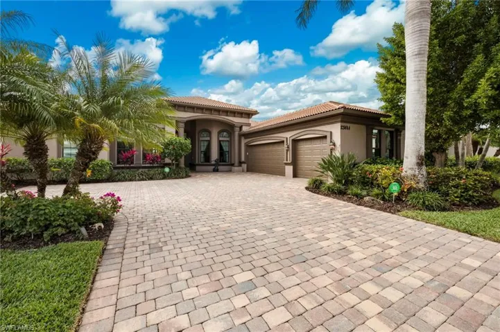 Mediterranean / spanish-style home featuring stucco siding, an attached garage, decorative driveway, a tile roof, and french doors
