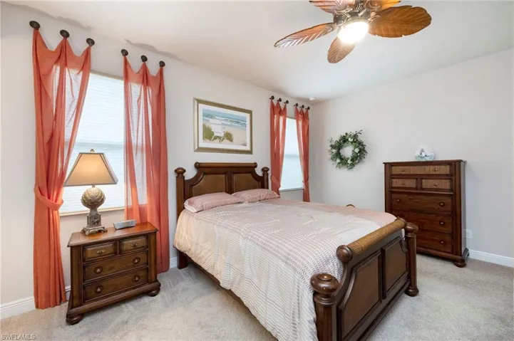 Bedroom with light carpet and ceiling fan