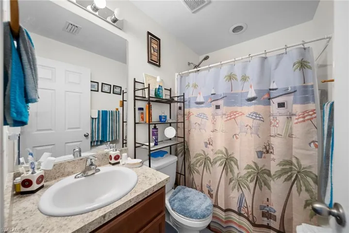 Bathroom featuring vanity and curtained shower