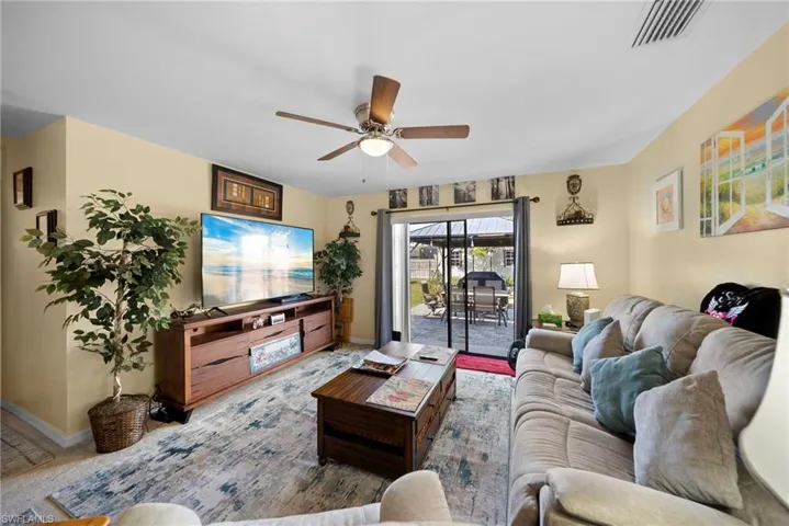 Living room with ceiling fan and carpet