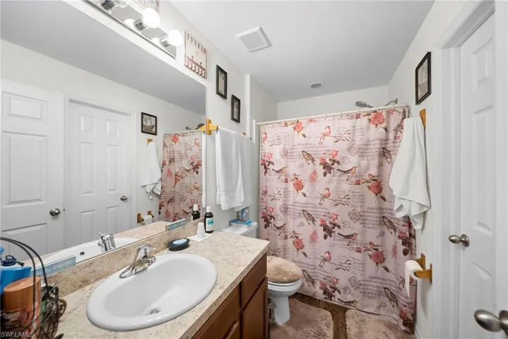 Bathroom featuring vanity and a shower with curtain