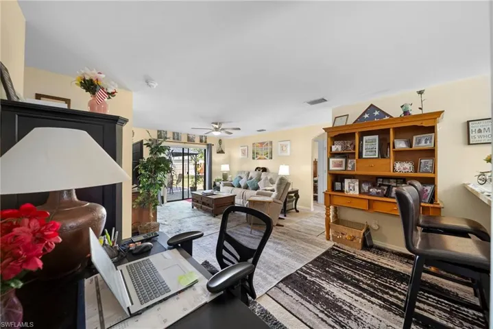 Office with ceiling fan and baseboards