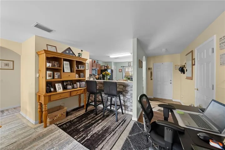 Office space featuring arched walkways and baseboards