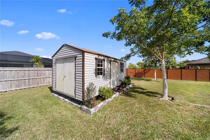 View of shed with a fenced backyard