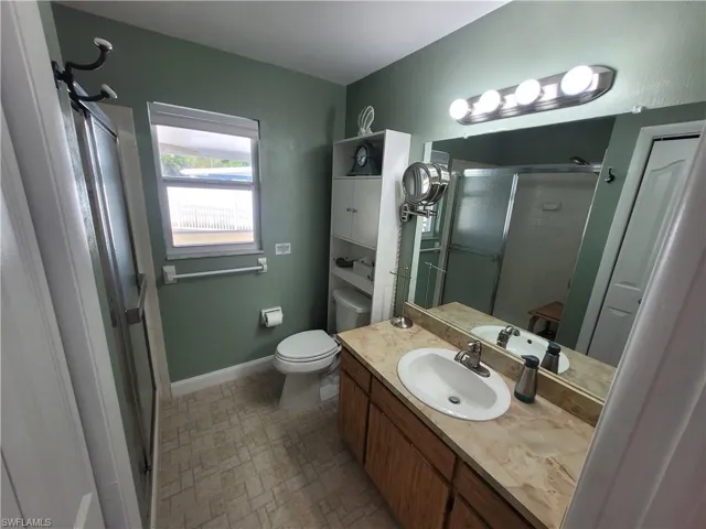 Bathroom with a stall shower and vanity