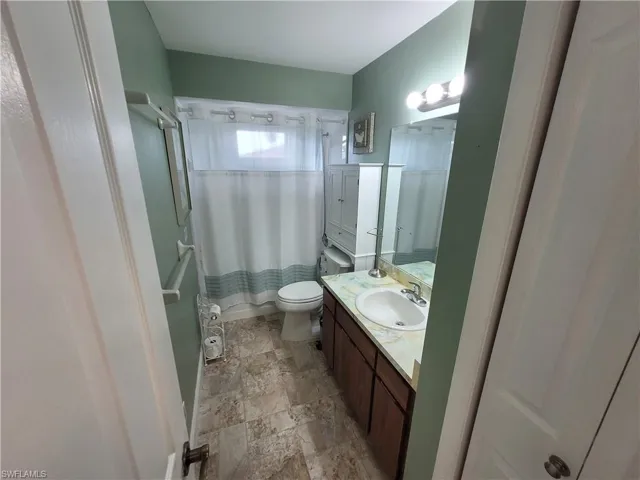 Bathroom with vanity and stone finish floors
