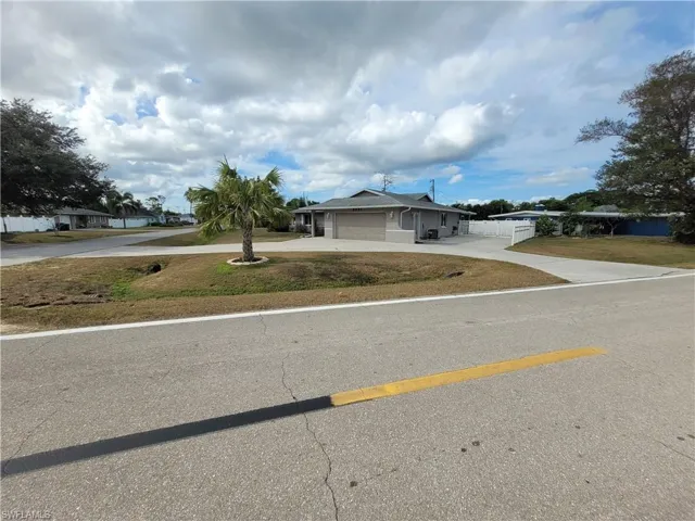 View of front of property with driveway and an attached garage