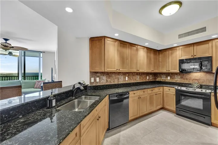 Rich wood cabinetry offers lots of storage and spacious countertops