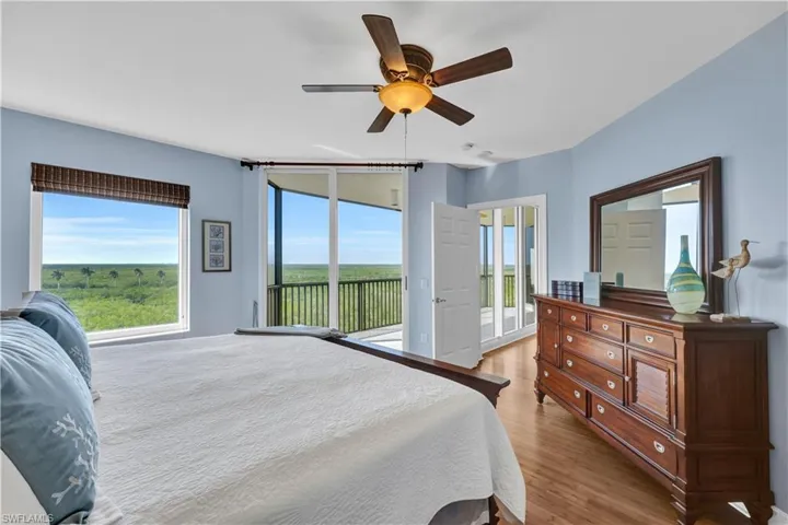 Primary Bedroom featuring king bed , sliders outside, and ceiling fan
