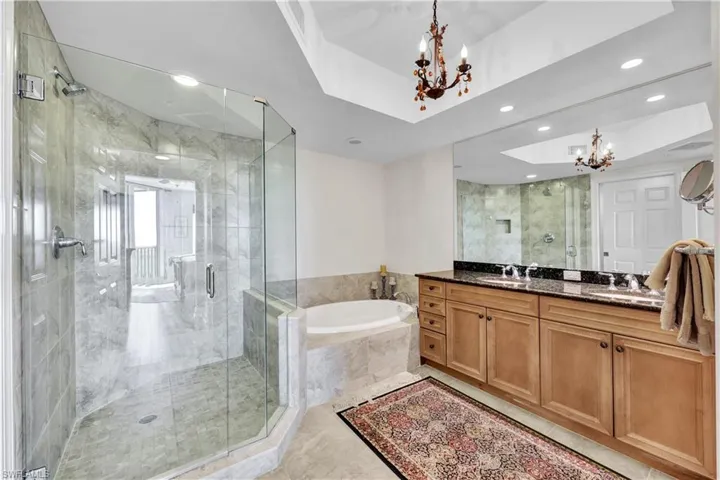 Dual granite vanity, separate shower & tub, private commode and coffered ceiling