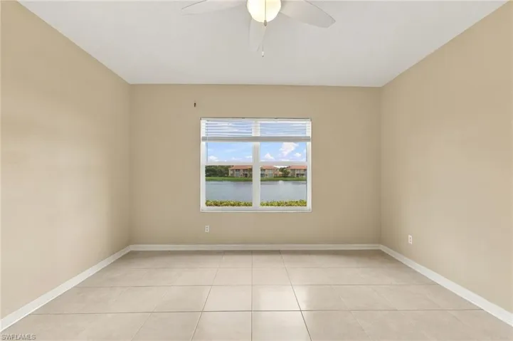 Recessed window, ceiling fan, neutral wall tones, large format floor tiles, and a natural water feature