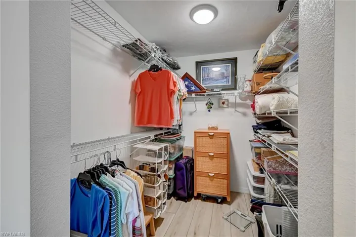 Quite ample walk in closet with shelving that will accommodate extra storage as well
