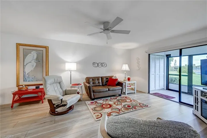 Spacious living room overlooks Lanai, Lake & Wetlands Preserve