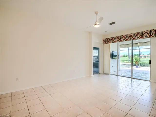 Empty room featuring ceiling fan and light tile patterned flooring