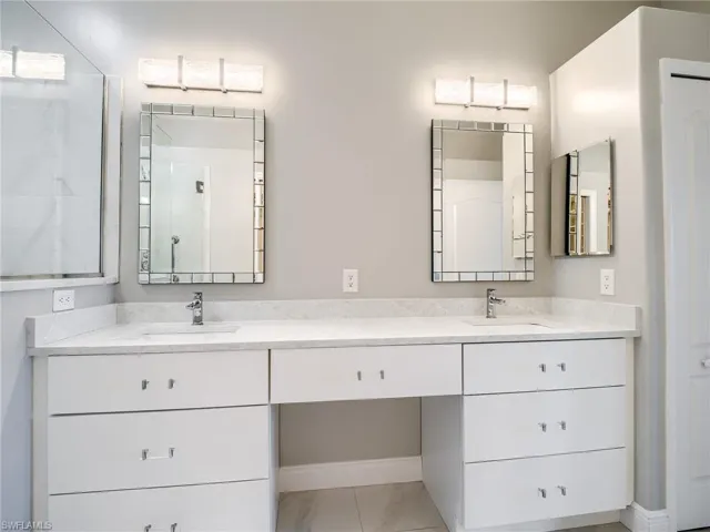 Bathroom with tile patterned floors and vanity