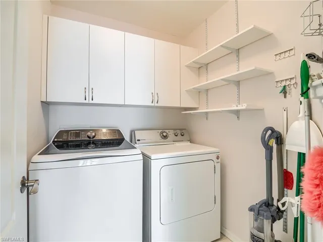 Laundry room with cabinets and separate washer and dryer
