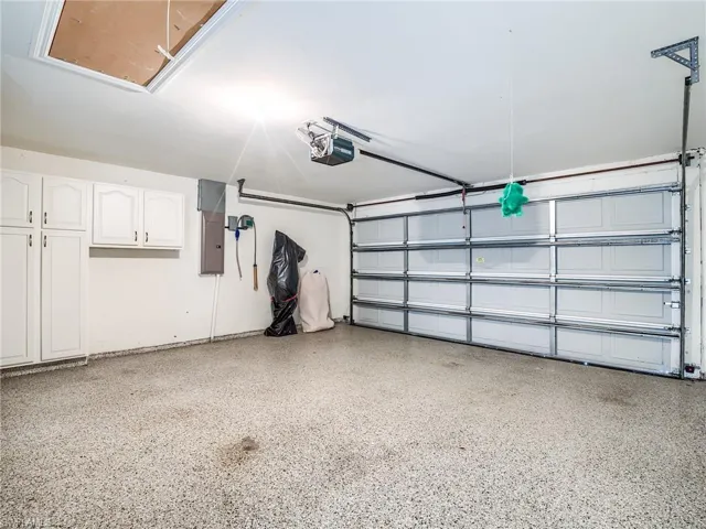 Garage with a garage door opener and electric panel