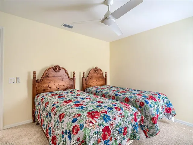 Carpeted bedroom with ceiling fan