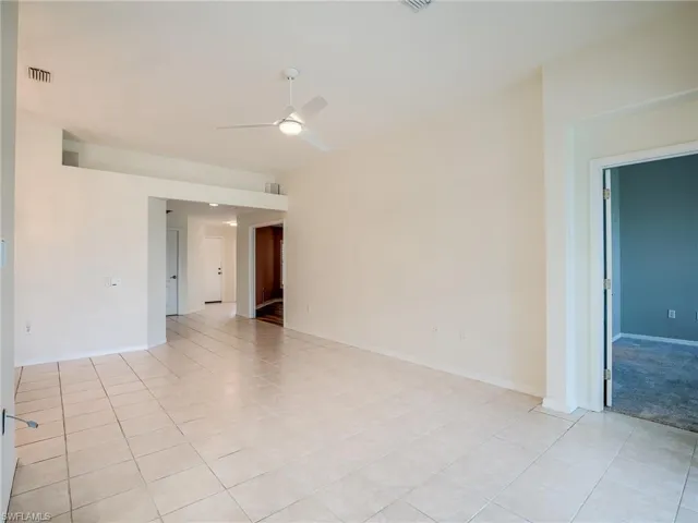 Tiled spare room with ceiling fan
