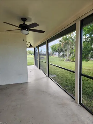 Unfurnished sunroom with ceiling fan