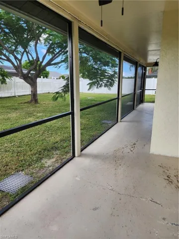 Unfurnished sunroom with ceiling fan