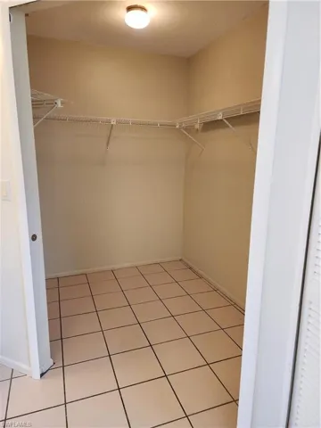 Walk in closet featuring light tile patterned flooring