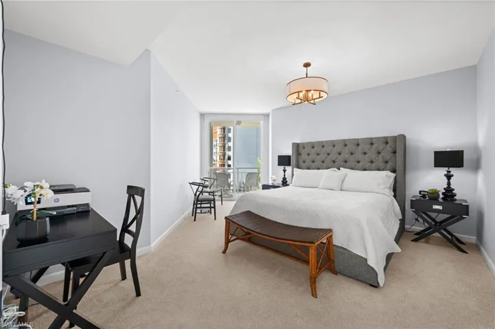 Bedroom featuring light colored carpet and floor to ceiling windows