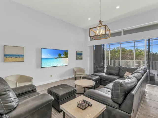 Living room with a notable chandelier and light tile patterned flooring