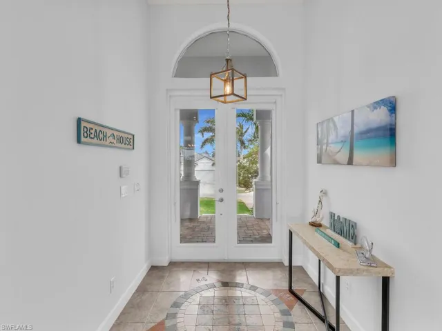Entrance foyer with light tile patterned floors