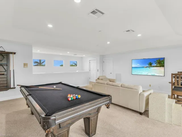 Playroom featuring light colored carpet and billiards