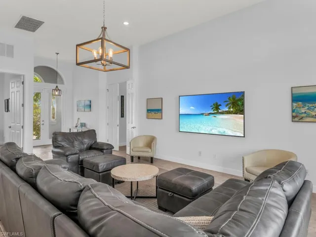 Living room with an inviting chandelier and high vaulted ceiling