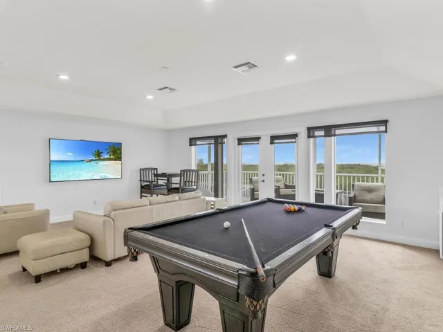 Playroom featuring french doors, a wealth of natural light, pool table, and light colored carpet
