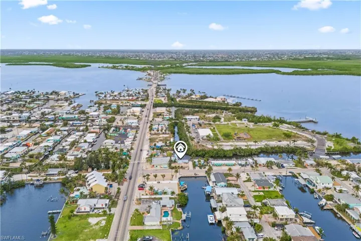 Positioned in the heart of Matlacha, this prime lot offers deep water access, wide-open views, and the opportunity to immerse yourself in the area's wildlife and vibrant island culture.