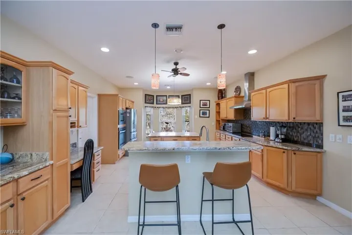 Kitchen features two islands, one with seating