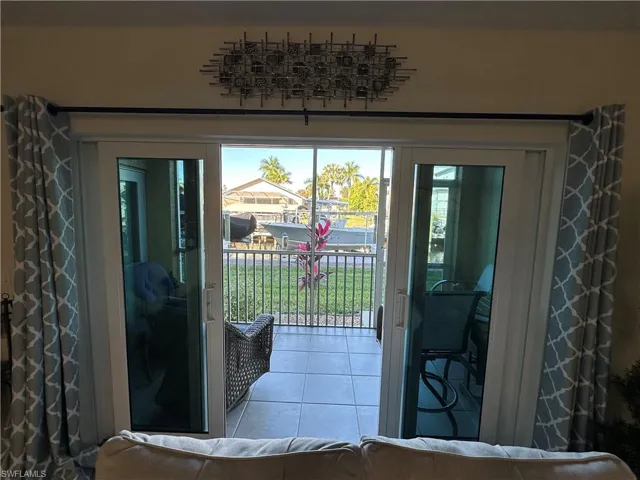 Doorway to outside with tile patterned floors