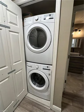 Washroom featuring stacked washer / dryer