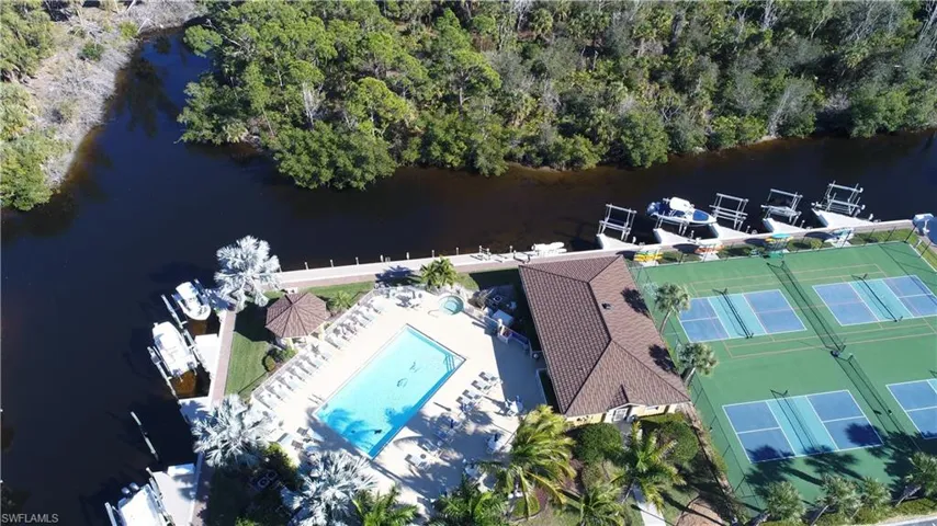 Bird's eye view of a nearby body of water and a pool area