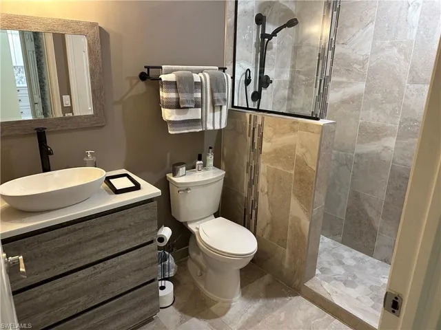 Full bathroom with walk in shower and vanity