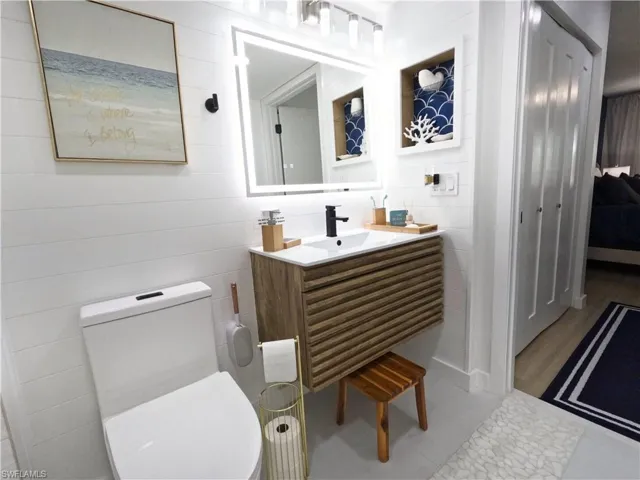 Bathroom with vanity and connected bathroom