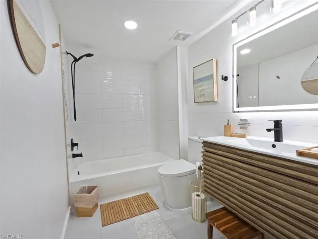 Full bathroom featuring vanity, shower / washtub combination, tile patterned floors, and recessed lighting